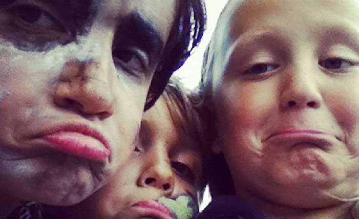 Funny close up of two boys and a girl with makeup