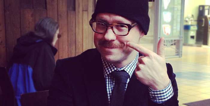 Steve Fisher pointing at his moustache