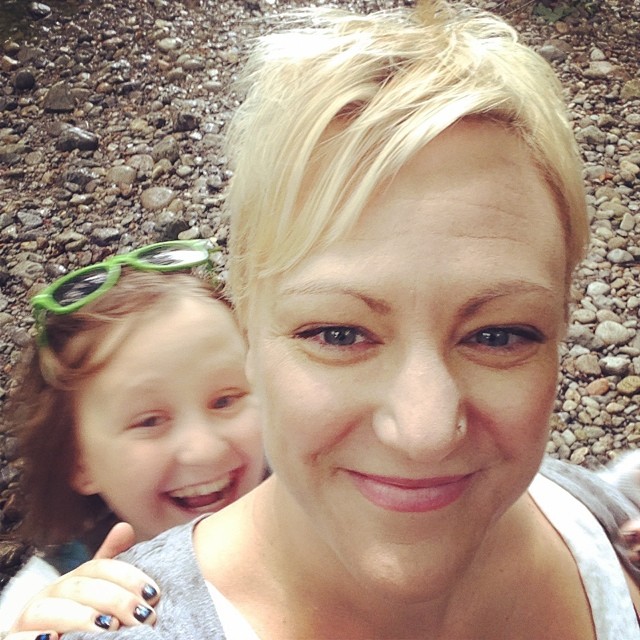 daughter smiling behind happy mom